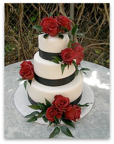 The cake base is a silver plateau black and white wedding cakes