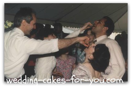 groom feeding the guests chocolate covered strawberries