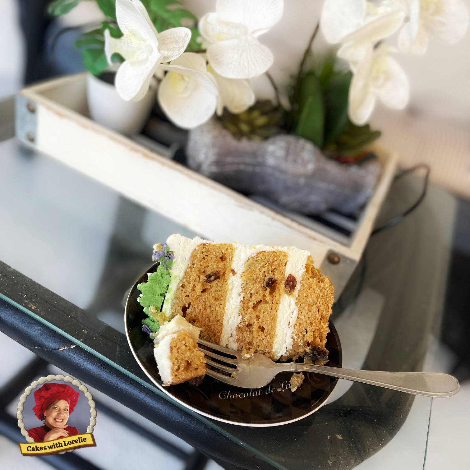A sice of sweet potato cake filled and frosted with browned butter frosting. rum raisin sweet potato cake