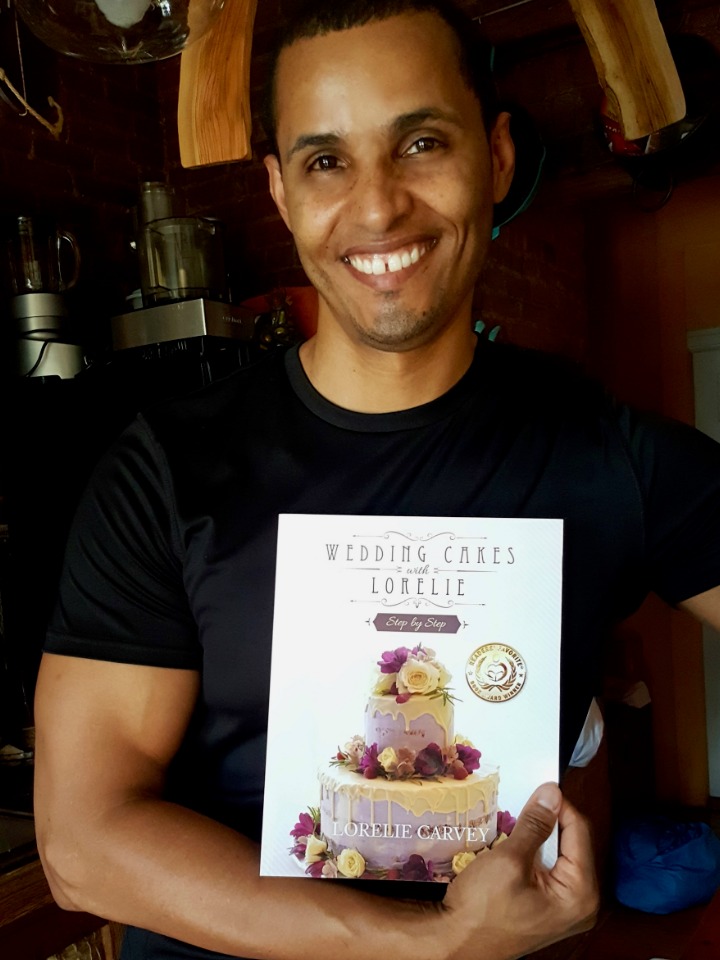 happy customer holding wedding cakes with Lorelie step by step book in print